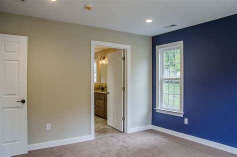 Master Bedroom With Blue Accent Wall Looking Into On Suite ©balducci