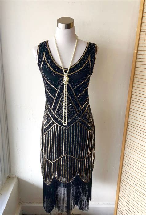 Maybe you would like to learn more about one of these? 1920s Black Flapper Great Gatsby Dress with Gold Beading ...