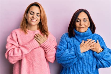 Latin Mother And Daughter Wearing Casual Clothes Smiling With Hands On Chest Eyes Closed With