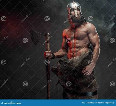Naked Nord Warrior Posing In Dark Background With Axe Stock Photo