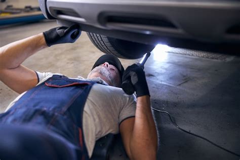 Premium Photo Professional Auto Mechanic Inspecting Car At Service