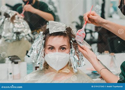 Woman Dyes Her Hair In A Barbershop The Process Of Dyeing Her Hair With Foil Stock Image