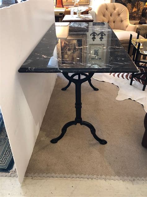 Melamine panel top, metal tube with white powder coating features: Sleek Black and White Marble and Wrought Iron Console ...