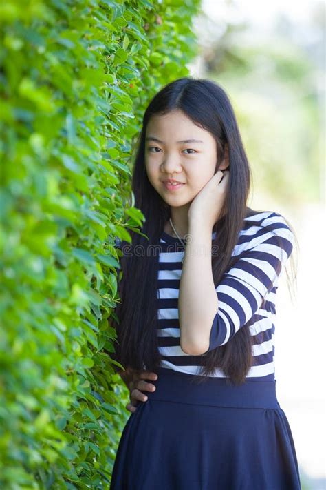 Portrait Of Younger Asian Teen With Happiness Emotion And Smiling Face In Green Park Stock Image