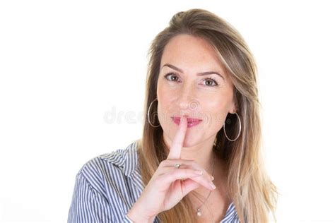 portrait of woman holding index finger on lips quiet gesture silence sign on white background