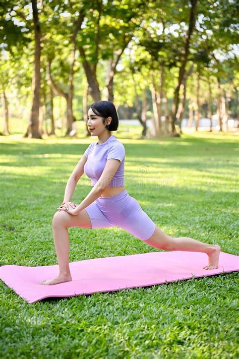 Attractive Asian Woman Stretching Her Legs Warm Up Before Workout Practicing Yoga Stock Image
