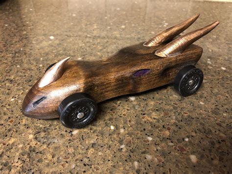 It's a good idea to use a final clear coat of paint if you are using racing stripes or decals. Pin on Pinewood derby cars