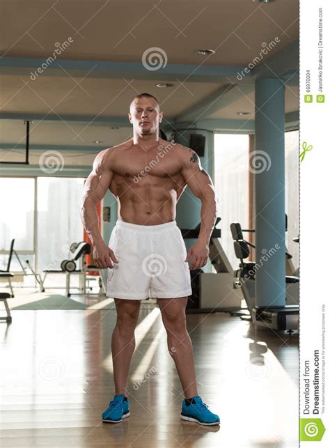 Young Bodybuilder Flexing Muscles Stock Photo Image Of Adult Model
