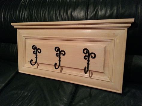 Adding molding to kitchen cabinet doors. Coat rack/hanger. Old cabinet door converted to coat rack ...