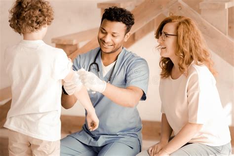 Positive Delighted Doctor Treating His Patient Stock Photo Image Of