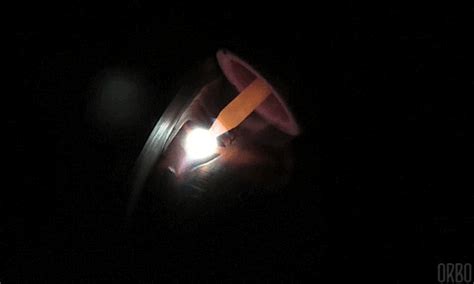 A Person Holding A Flashlight In The Dark