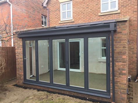 Modern Look Conservatory Complete With Grey Aluminium Bi Fold Doors And