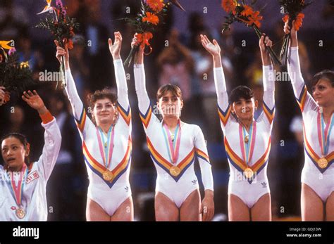 Romanian Gymnastics Team Stands On Victory Stand With Gold Medals For