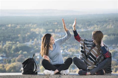 Two Smiling Girls Having Fun Sitting On A Hill Sunny Day Stock Image Image Of Female Sitting