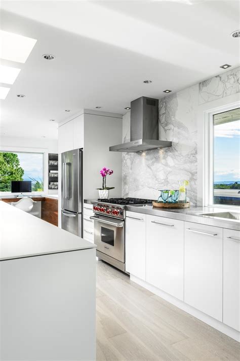 A lower countertop areas gives prep surface for baking and use of small appliances. White, Open-Plan Kitchen | HGTV