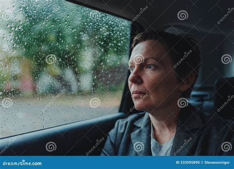 Worried Businesswoman Waiting In The Car And Looking Out The Window