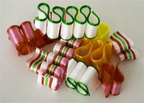 One Broken Piece Of Ribbon Candy Beside Filled Bowl Stock Image