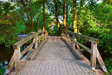Beautiful View Of A Small Wooden Bridge Over A River Stock Photo