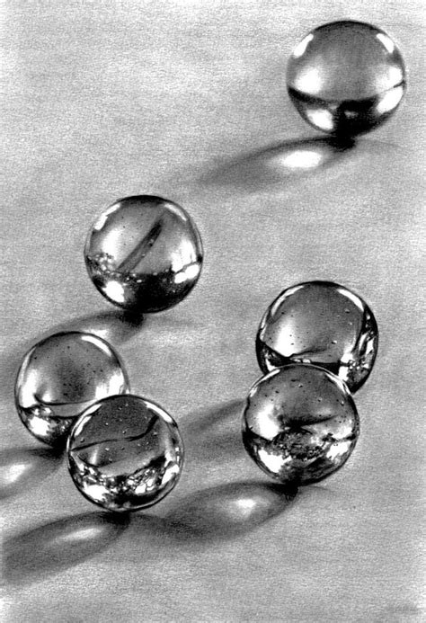 Four Glass Balls Sitting On Top Of A Table Next To Each Other In Black