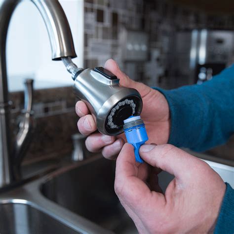 Attach the sprayer hose to the base of the faucet and fasten it with your pliers. replacing kitchen sink cartridge