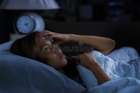 Depressed Young Asian Woman Sitting In Bed Cannot Sleep From Insomnia