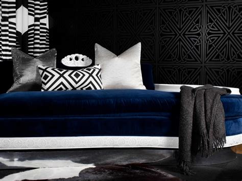The bed frame is black with a blue comforter. Art Deco Bedroom with Navy Blue Velvet Daybed | HGTV