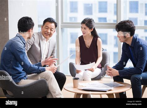 Chinese Business People Talking In Meeting Stock Photo Alamy
