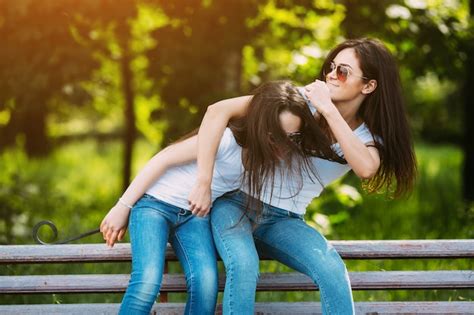 Free Photo Teenage Girl Rubbing Sisters Head Outside