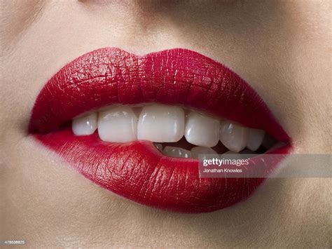 female with red lipstick biting lips close up bildbanksbilder getty images