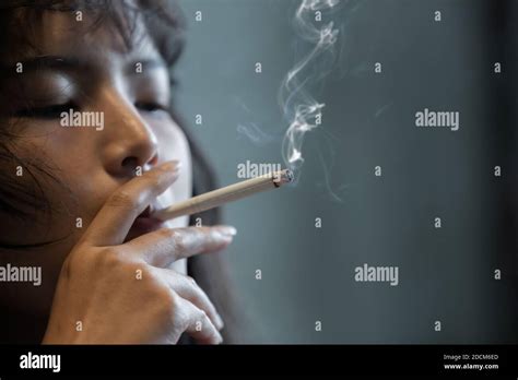 asian girl smoking and hopeless concept feeling be absent minded lonely girl concept stock