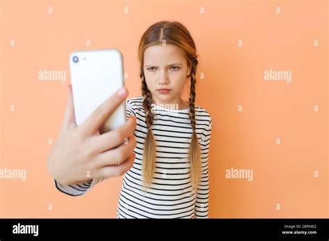Cute Little Girl Taking Selfie On Color Background Stock Photo Alamy