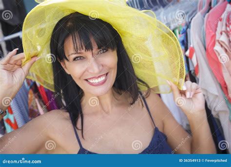 Playful Italian Woman Trying On Yellow Hat At Market Stock Image Image Of Shop People 36354913