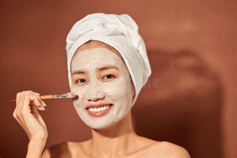 Beautiful Asian Woman Applying Facial Mask On Her Face Skin Care And Treatment Spa Natural