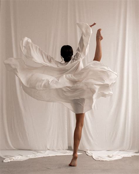 A Woman In White Is Dancing On The Floor