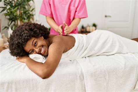 Young African American Woman Having Back Massage At Beauty Center Stock