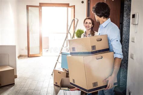 Young Couple Moving In Into New Apartment Stock Photo Image Of Males