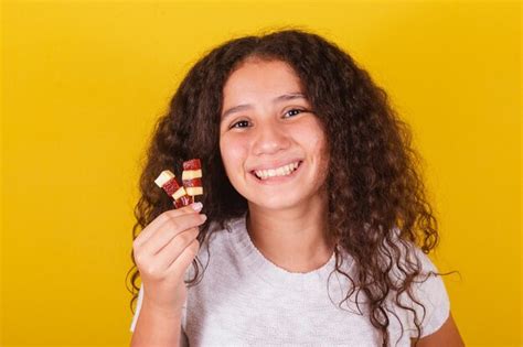 Premium Photo Afro Brazilian Latin American Curly Haired Girl Smiling Holding Cheese And Guava