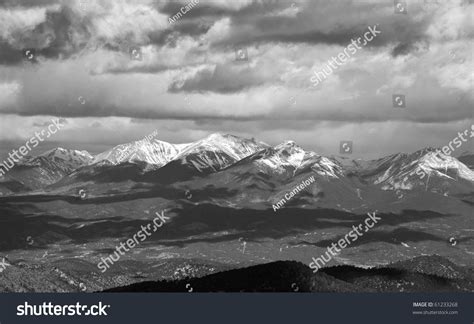 Snow Capped Mountain Range In The Colorado Rockies With Cloud Shadows