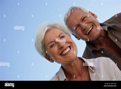 Senior Couple Bending Over Camera Stock Photo Alamy