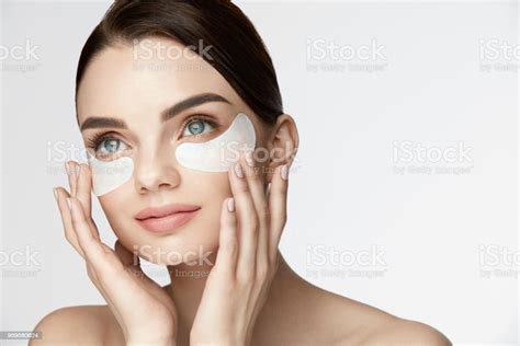 Beauty Face Skin Care Woman Applying Undereye Patches On Face Stock