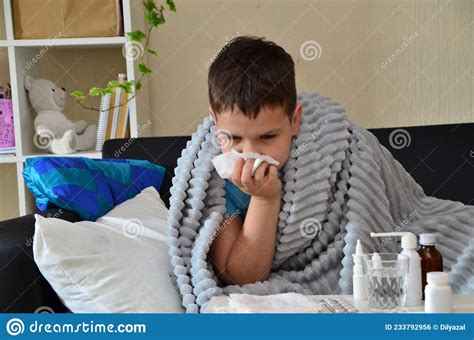 Sick Child Boy Lying In Bed With A Fever Resting At Home A Boy With A