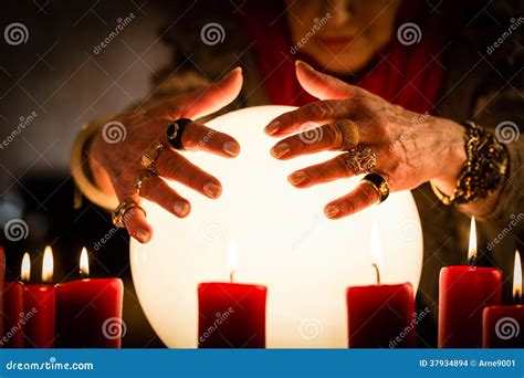 Soothsayer during a Seance or Session with Crystal Ball Stock Photo