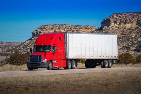 Eighteen Wheel Big Rig Tractor With Trailer On Highway Trucking