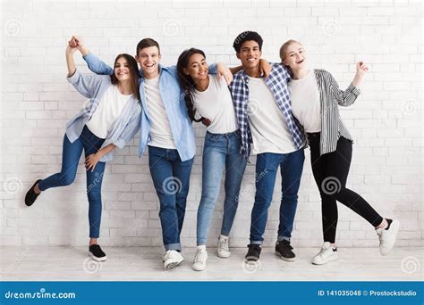 Happy Teenagers Having Fun And Posing Over White Wall Stock Photo