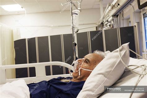 Senior Man Lying Down On Hospital Bed — European Illness Stock Photo