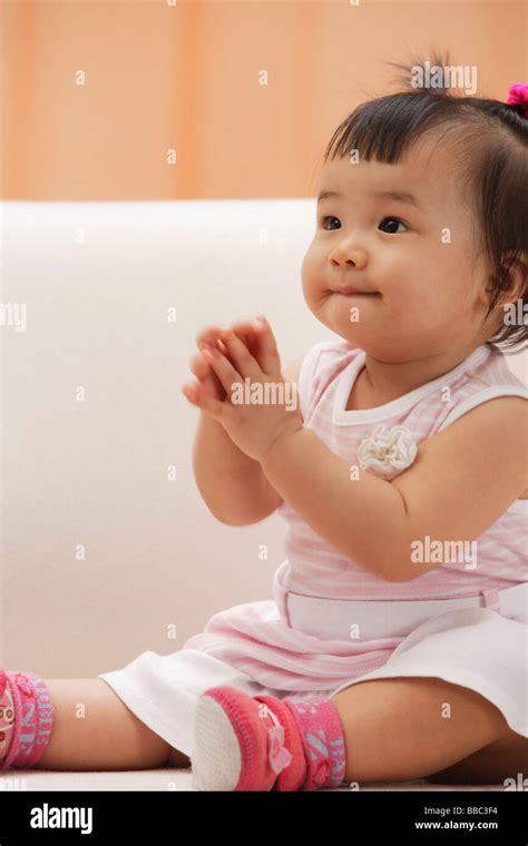 Baby Girl Sitting And Holding Hands In Prayer Stock Photo Alamy