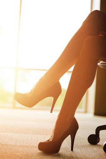 Elegant Crossed Legs And High Heel Shoes In Office Stock Photo