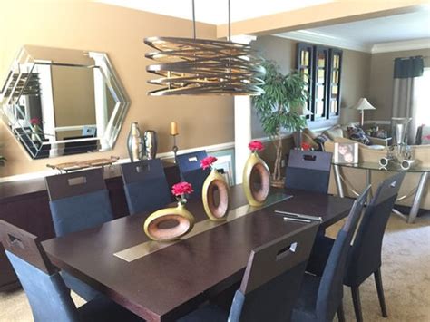 Anything more is uncomfortable and would be too high for the chair that suits the average. dining room light fixture height