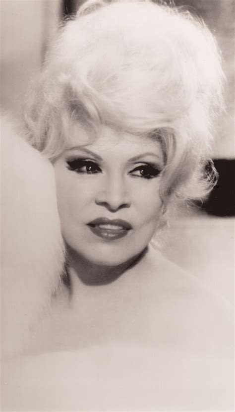 An Old Black And White Photo Of A Woman With Blonde Hair Wearing Eyeliners