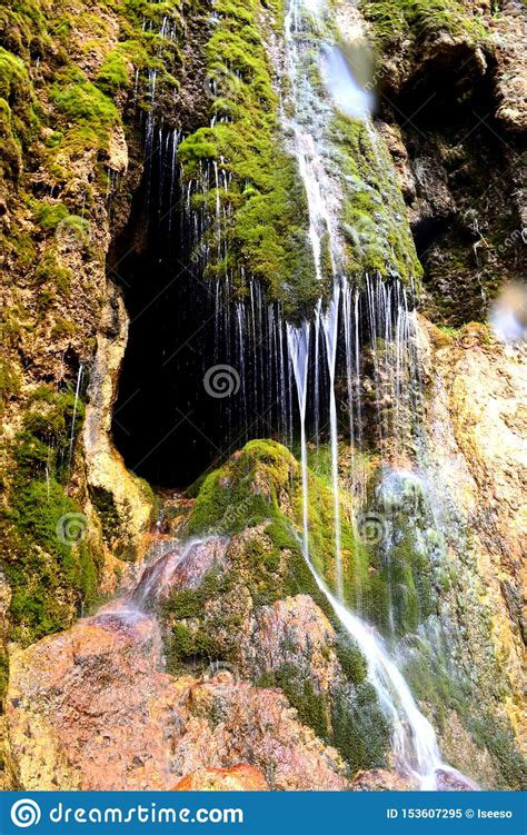 Cave Entrance Hidden Behind A Small Waterfall Stalactite Cave In The